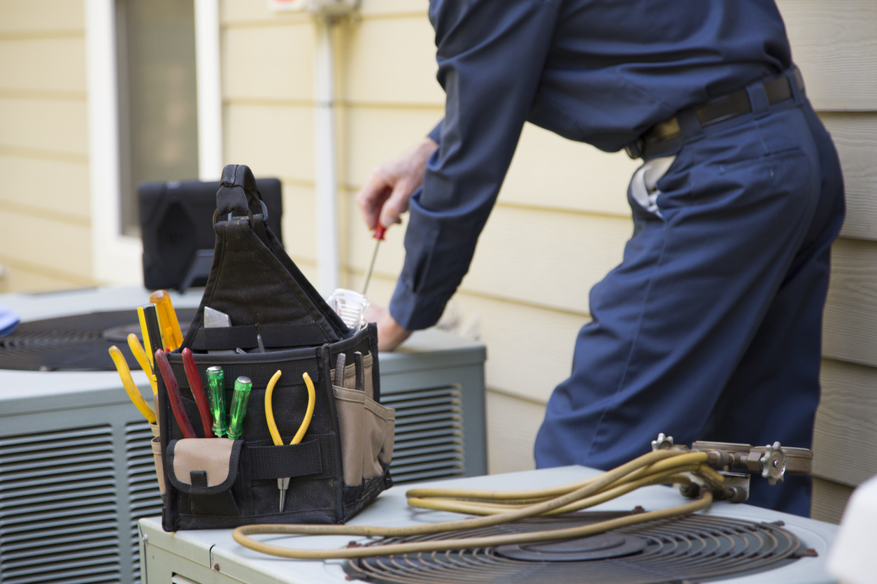 Technician services outside AC units and generator.