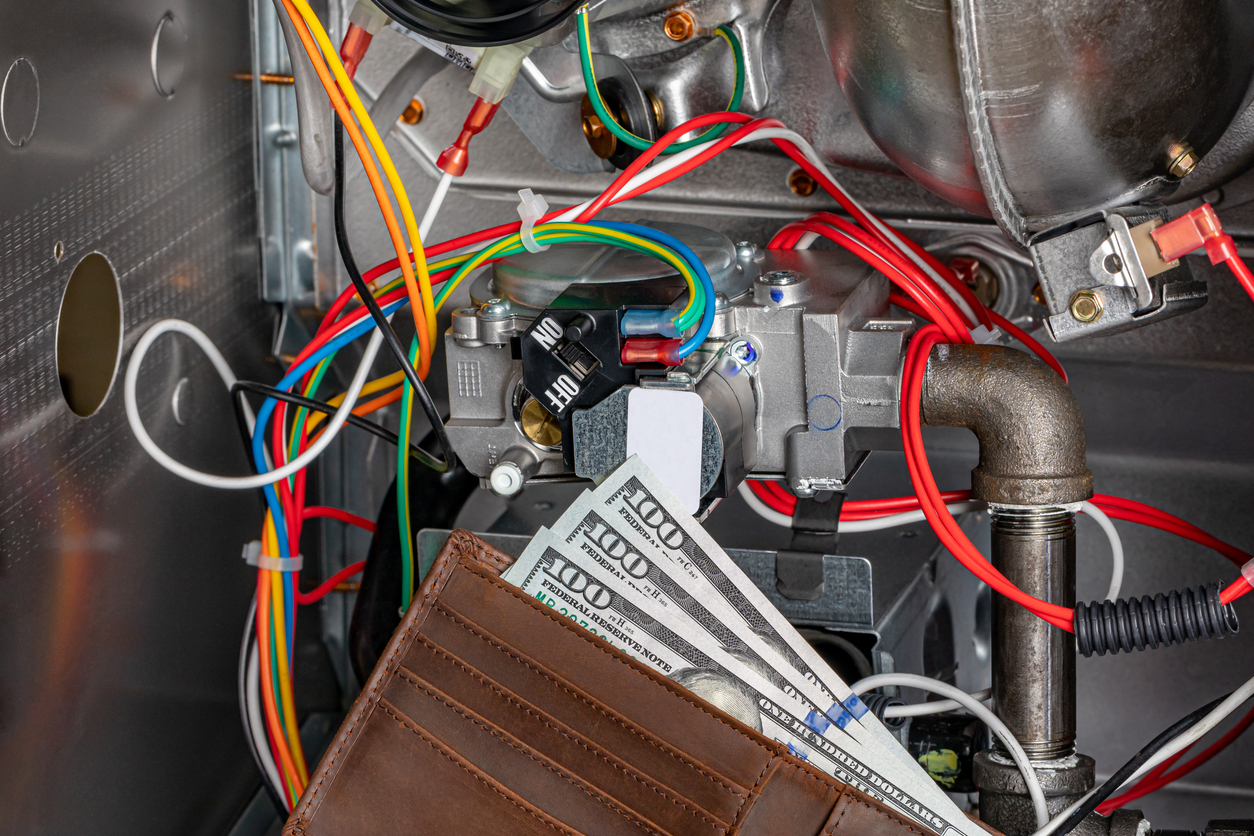 Wallet with cash in front of HVAC system components, illustrating HVAC tune-up costs in Charlotte, NC.