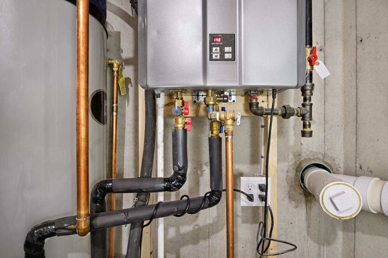 Tankless water heater connected to a recirculation system and a storage tank.